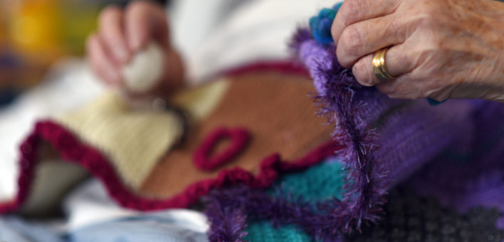 Generic photograph of an elderly patients' hands holding a blanket