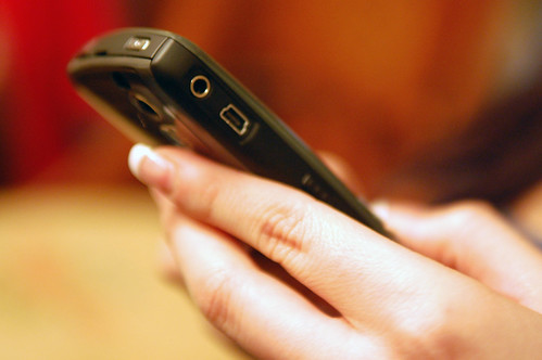 Generic photograph of a mobile phone in a hand