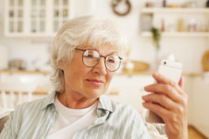 Mature woman looking at information on her phone