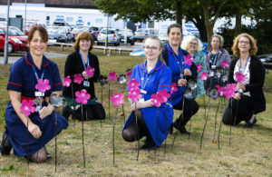Photograph of nurses with the Blooms for Blossom metal flower sculptures