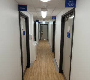 A corridor with doors on either side